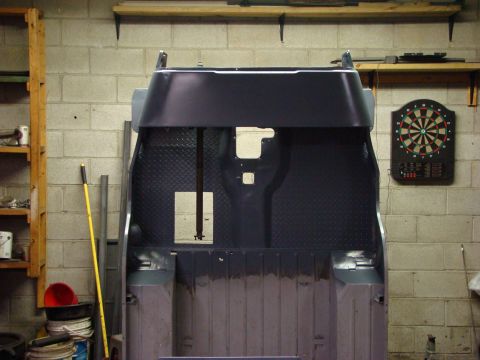 1948 Jeep Wrangler - The interior of a vehicle tub, possibly undergoing restoration, is shown in a workshop setting.