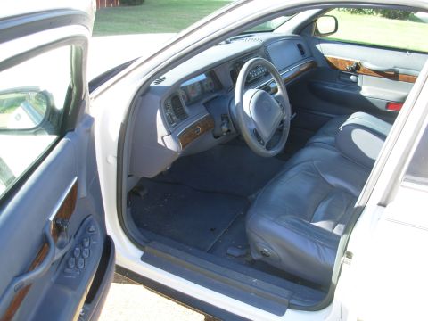 1998 Mercury Grand Marquis - The interior of a 1998 Mercury Grand Marquis is visible with the driver's side door open.