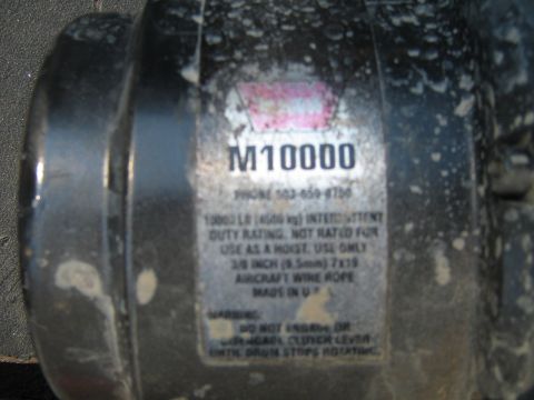 1990 Ford Bronco - A label on a winch indicates its model number and specifications, including a phone number.
