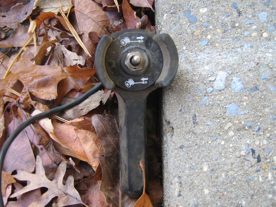Lawnmower throttle control lever with icons indicating speed settings