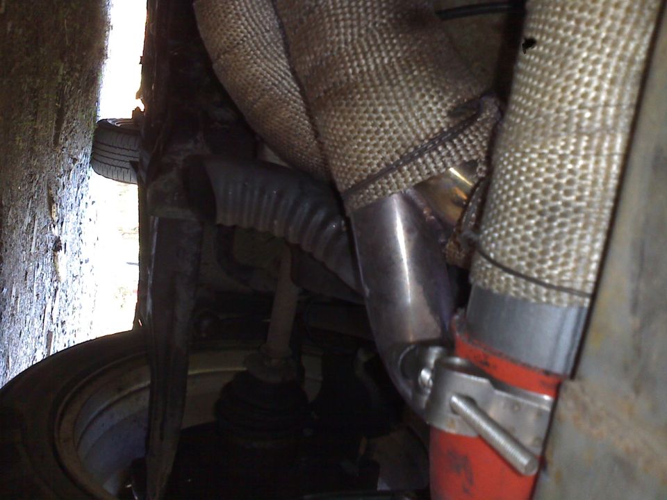 Exhaust manifold and piping with heat wrap and red hose clamp
