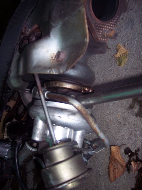 1995 Mitsubishi Eclipse - Close-up view of a turbocharger assembly, likely removed from a vehicle for repair or replacement.