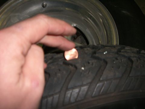 1988 Ford Bronco - Checking tire tread depth with a penny.