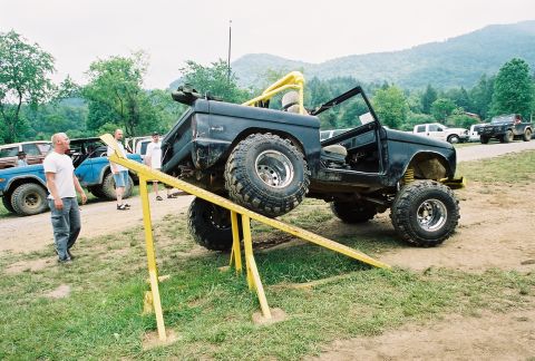 1972 Ford Bronco - A black 1972 Ford Bronco is positioned on a yellow ramp during an event.