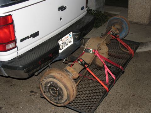 1984 Ford Bronco - A Ford Explorer is seen with a rear axle loaded onto a hitch-mounted carrier.