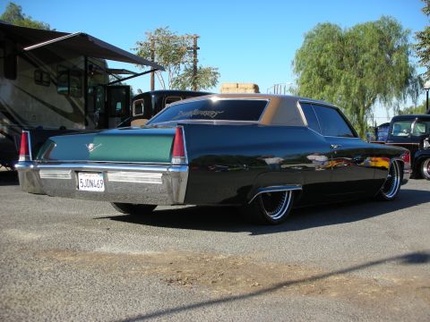 1998 Ford Crown Victoria - A custom Cadillac Coupe de Ville is parked next to an RV and a classic pickup truck.