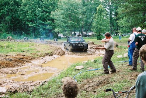 1972 Ford Bronco - A 4x4 vehicle tackles a challenging muddy course during an off-road event.