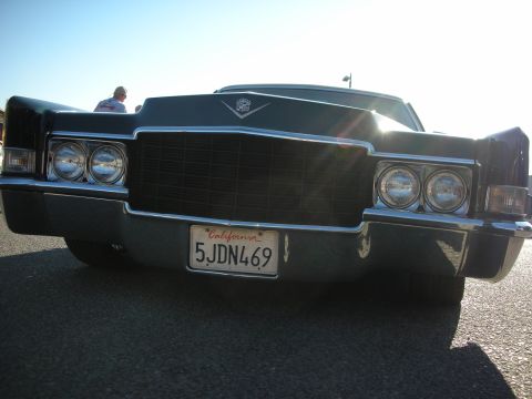 1998 Ford Crown Victoria - Front view of a 1970 Cadillac, showing its distinctive grille and quad headlights. California plate 5JDN469.