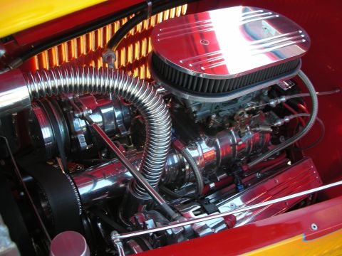 1998 Ford Crown Victoria - Detailed view of a custom engine bay, polished chrome components and a bright red finish.