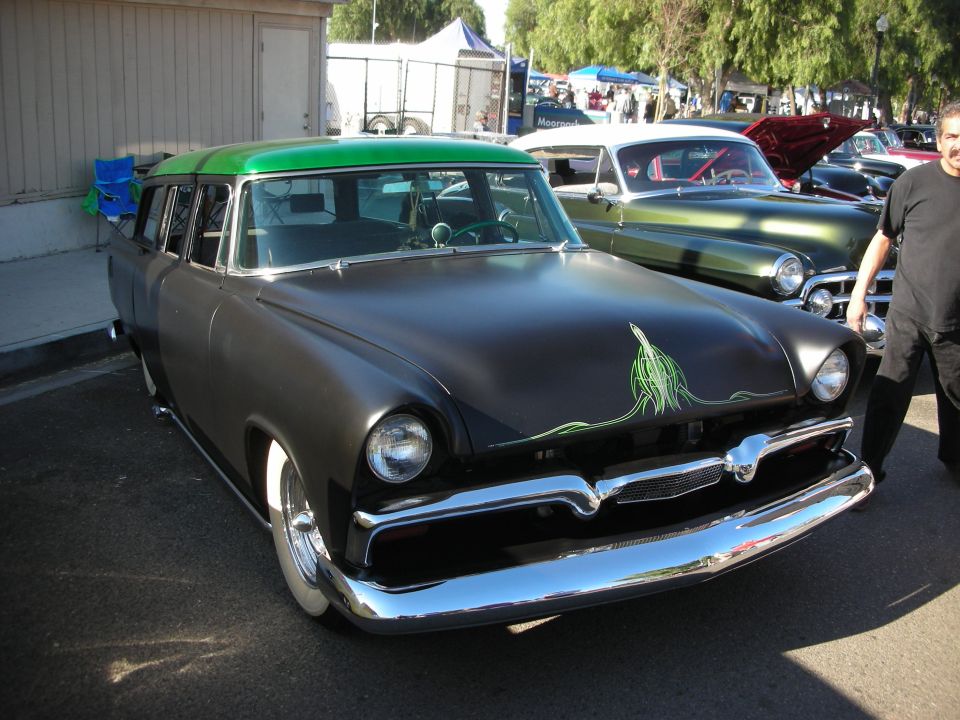 Black station wagon with green roof and green pinstriping on hood, parked outdoors