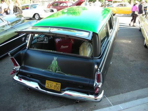 1998 Ford Crown Victoria - A customized station wagon with a two-tone paint job and pinstripe art is parked at an outdoor event.