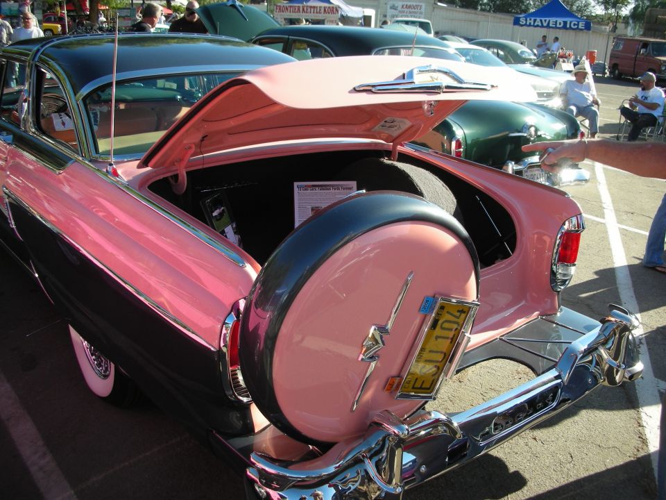 Pink and black 1956 Mercury Montclair rear view with continental kit and spare tire