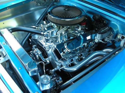1998 Ford Crown Victoria - A highly polished V8 engine with custom headers and air intake is showcased in a blue engine bay.