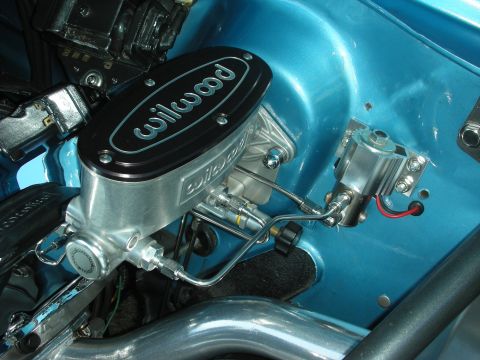1998 Ford Crown Victoria - Close-up of a Wilwood brake master cylinder and associated plumbing, mounted in a blue engine bay.