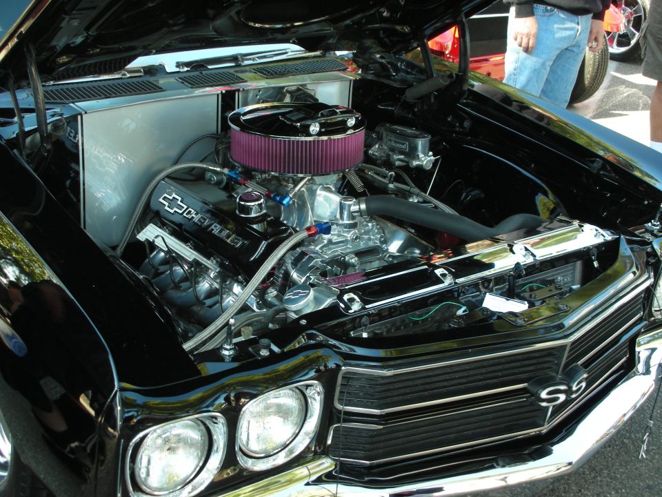 Black Chevrolet engine bay with chrome details and a purple air filter. SS badge on the grille