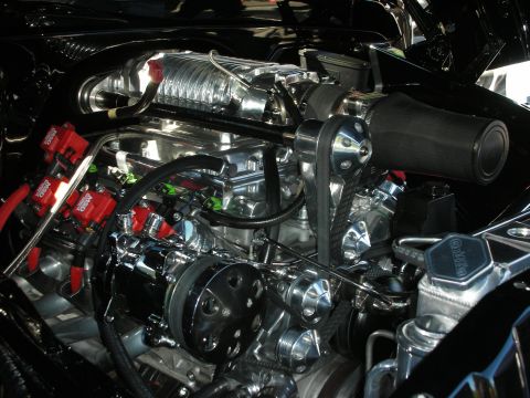 1998 Ford Crown Victoria - Close-up view of a highly customized engine bay with polished components and performance upgrades.