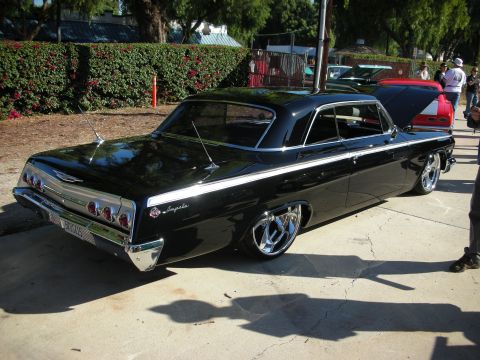 1998 Ford Crown Victoria - Custom 1961 Chevrolet Impala at a car show, with other vehicles in the background.