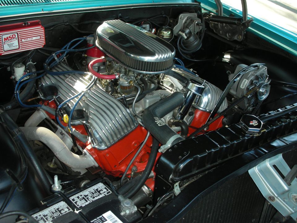V8 engine with chrome valve covers, air cleaner, and MSD ignition box. Battery visible