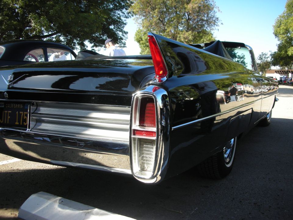 Black convertible with prominent tail fins and chrome bumper. California license plate JTF 175 visible