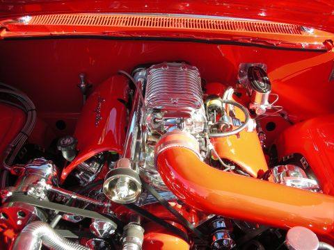 1998 Ford Crown Victoria - A highly customized engine bay is shown, polished chrome components and vibrant red and orange paint.