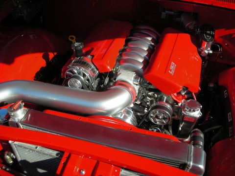 1998 Ford Crown Victoria - The engine bay features a polished intake manifold and a bright red engine block.