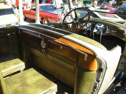 1998 Ford Crown Victoria - The interior of a classic car shows off its vintage design with green upholstery and wood accents.