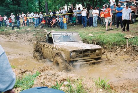 1972 Ford Bronco - Ford Bronco attempts to drive through a deep mud pit during an off-road event.