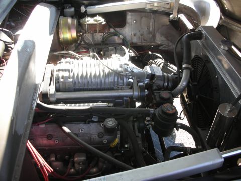 1998 Ford Crown Victoria - Close-up view of a supercharged V8 engine bay, showing the supercharger and other components.