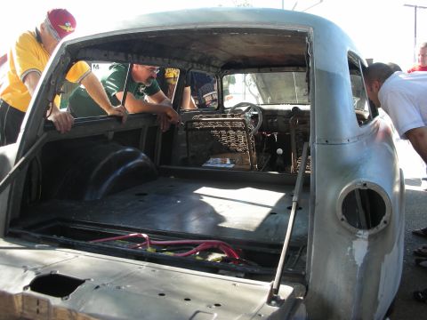 1998 Ford Crown Victoria - A customized station wagon is being worked on by several people, with its rear cargo area and interior exposed.