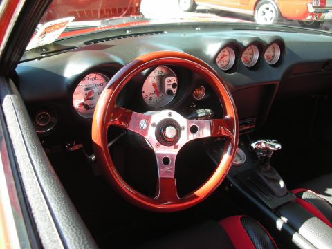 1998 Ford Crown Victoria - The interior of a car shows a wooden steering wheel and custom gauges.