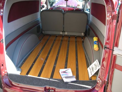 1998 Ford Crown Victoria - The interior of a custom panel van features a polished wood floor and comfortable seating.