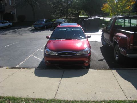1998 Ford Contour - Front view of a red 1998 Ford Contour parked in a lot.