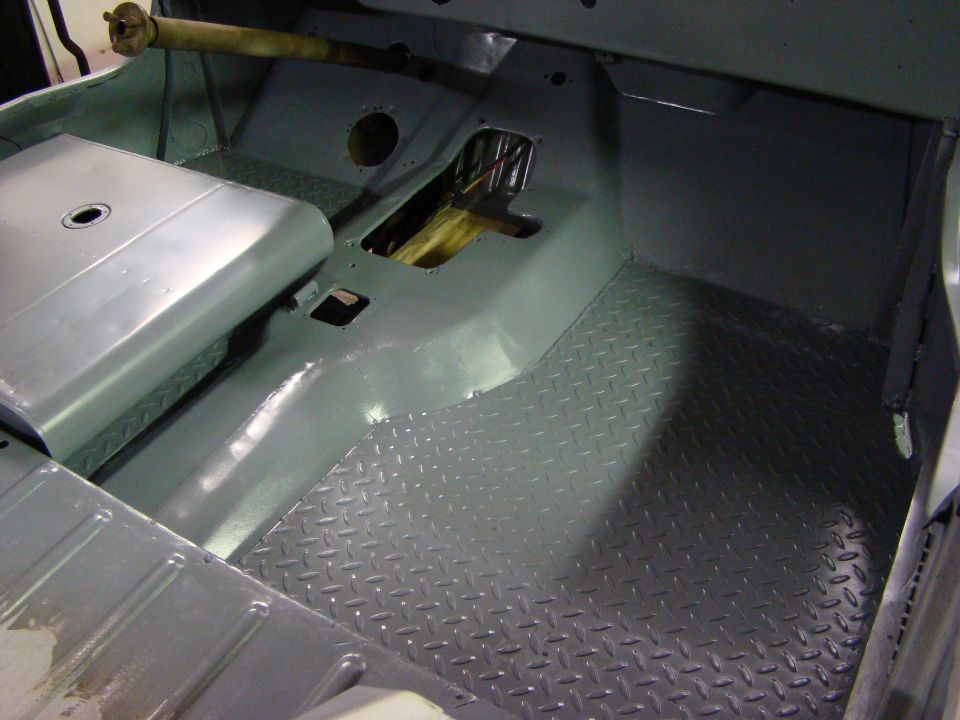 Gray diamond plate flooring and painted metal interior of a vehicle