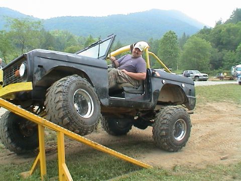 1972 Ford Bronco - A man sits in a modified 1972 Ford Bronco as it is positioned on an off-road ramp.