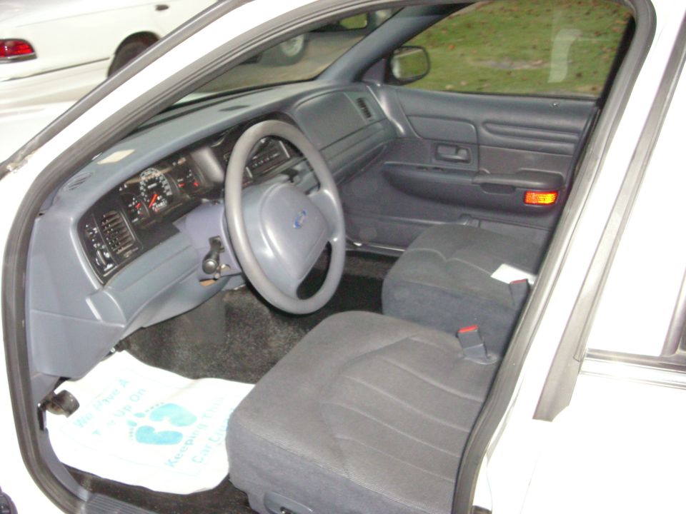Interior of a 2001 Ford Crown Victoria, showing dashboard and seats
