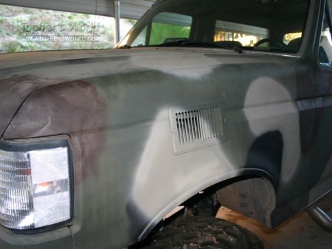 1996 Ford Bronco - This Ford Bronco is undergoing a camouflage paint job, showing its front fender and headlight detail.
