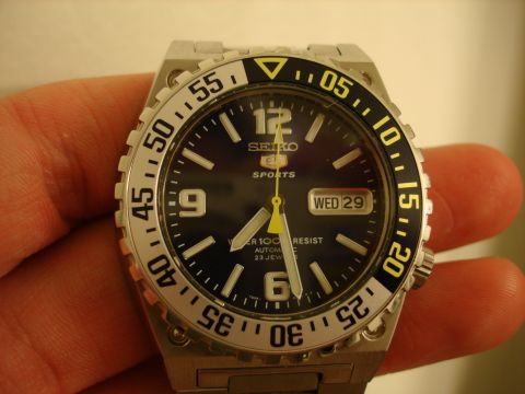 1994 Ford Bronco - A close-up of a Seiko 5 Sports automatic watch held in a hand.