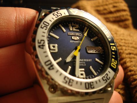 1994 Ford Bronco - A close-up of a Seiko 5 Sports watch, showing its dial and rotating bezel.