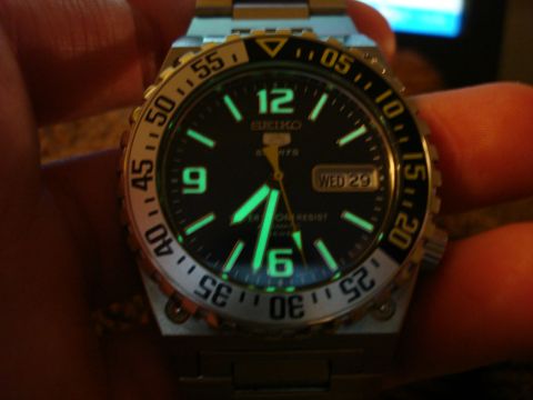 1994 Ford Bronco - Close-up of a Seiko 5 Sports watch face, luminous hour markers and hands, with the date displaying "WED 29".