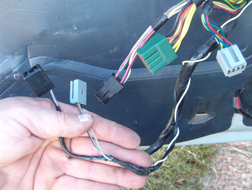 On cars without keyless entry, the trunk switch feed (Bk/Wh) can be used to power the fuel door release.  But on this one, I had to tap that same wire going into the DDM.