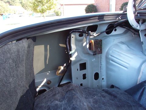 1998 Mercury Grand Marquis - This is where the cup can be accessed. The rubber drain hose can also be pulled up from here. The gold metal shield protects the inertia fu…