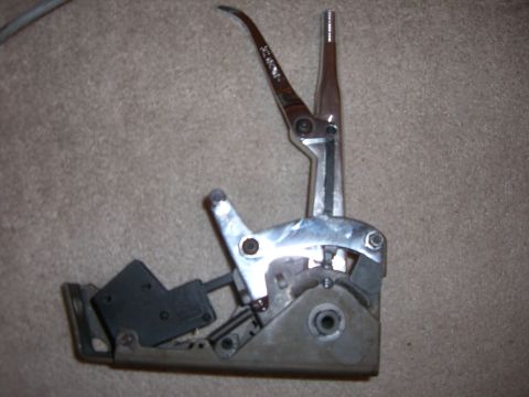 1988 Ford Bronco - Automatic transmission shifter lever assembly shown on a carpeted surface.