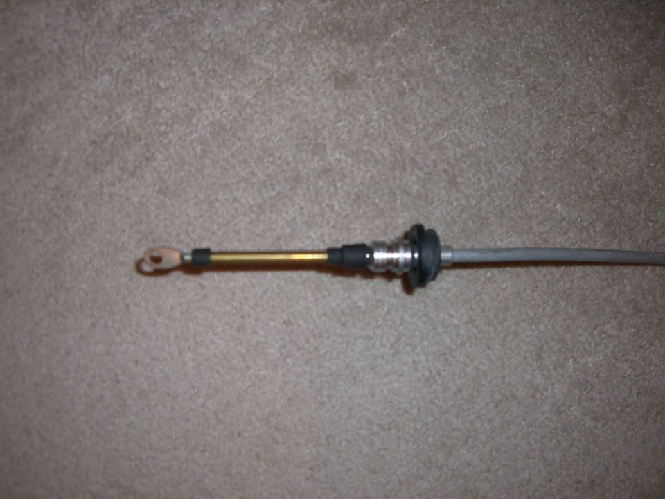 Shift cable with brass housing and metal fittings on carpet