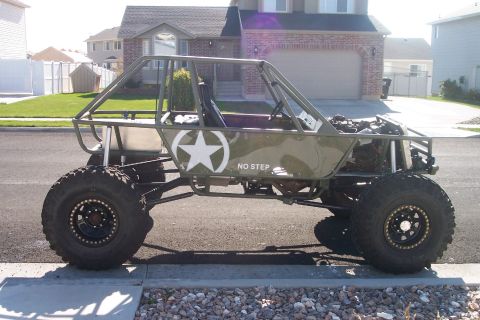 1995 Ford Bronco - Custom off-road buggy with a roll cage and large tires is parked on a suburban street.