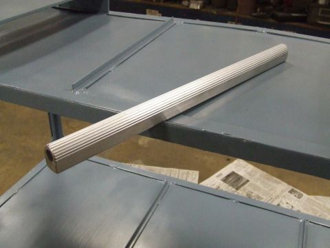 1967 Ford Bronco - A fluted metal trim piece is shown on a gray painted surface.