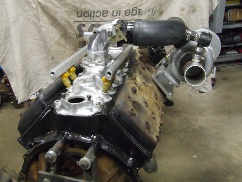 1967 Ford Bronco - Close-up of a V8 engine block modified with a turbocharger and custom intake.