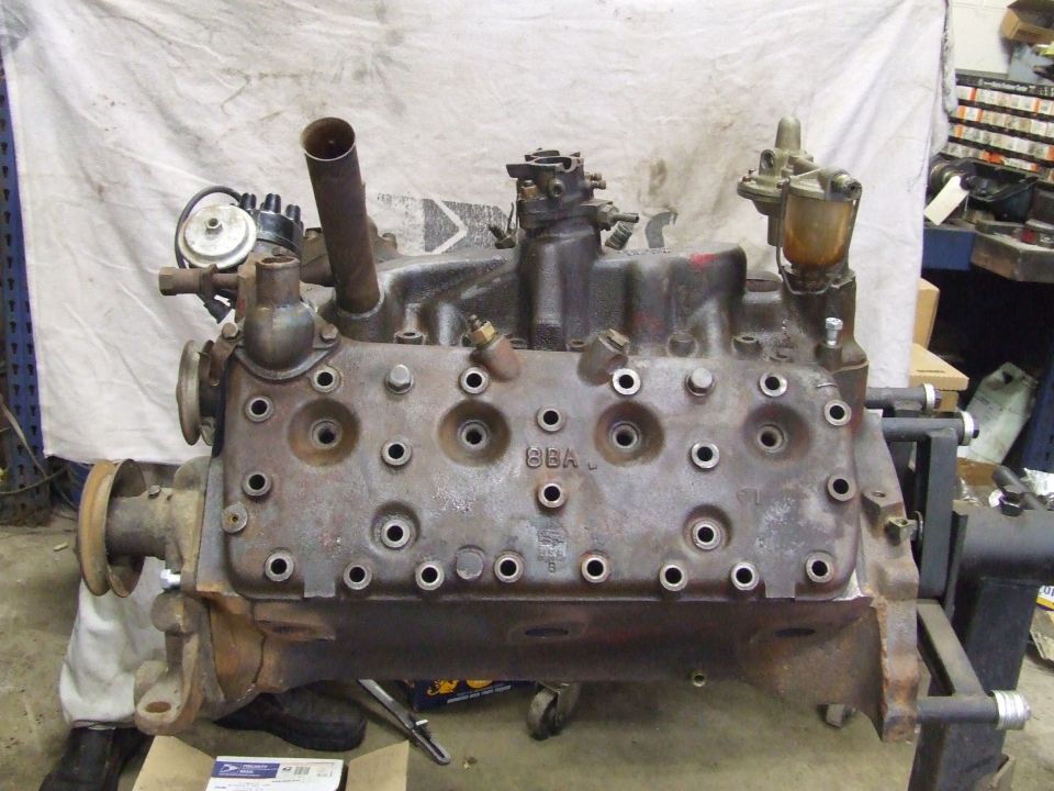Ford Flathead V8 engine on stand, front view. Engine block has '6BA' stamped on it