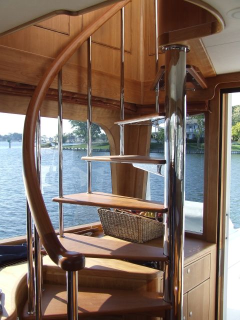 1976 Ford F-150 - Interior view of a boat's wooden spiral staircase with chrome accents.