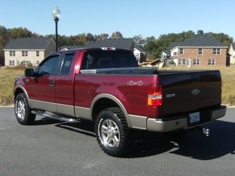 2005 Ford F-150 - This 2005 Ford F-150 pickup truck is shown from a 3/4 front angle, aftermarket wheels and tires.