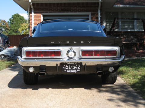 1968 Shelby GT500 - The rear of a black 1968 Shelby GT500 with its distinctive taillights and Shelby badging is shown.